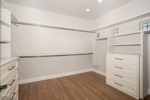 an empty room with wooden floor and a window