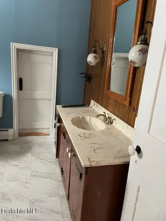 a bathroom with a sink a vanity and a mirror