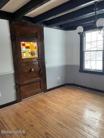 a view of a room with wooden floor and windows
