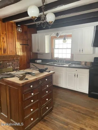 a kitchen with a stove window and cabinets
