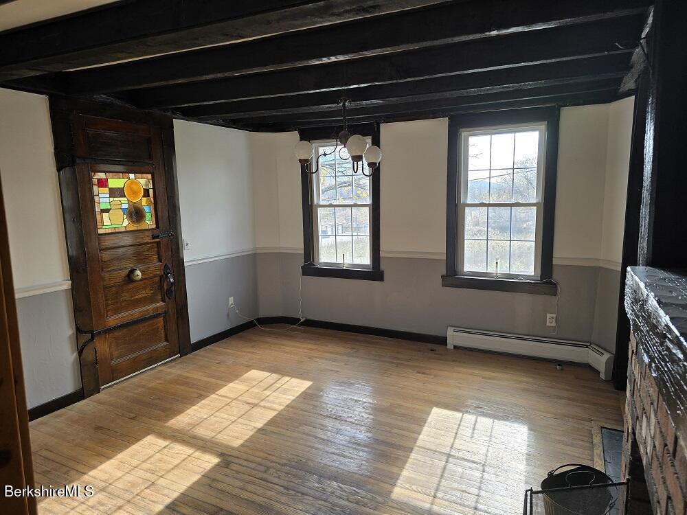 18 West Mountain Road Cheshire, MA 01225 - Photo 9 of 29 a view of an empty room with a window and wooden floor
