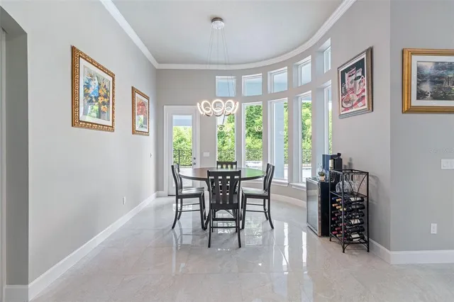 a bed sitting in a spacious bedroom next to a window and dresser
