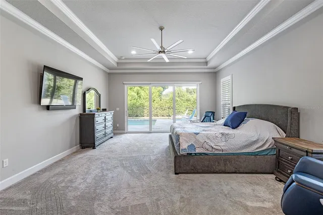 a living room with furniture wooden floor and a large window
