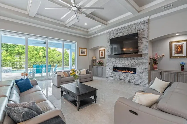 a living room with furniture fireplace and a large window