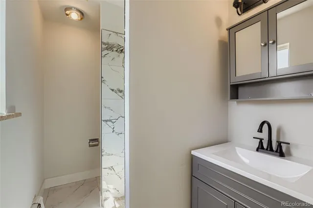 a bathroom with a sink a mirror and vanity