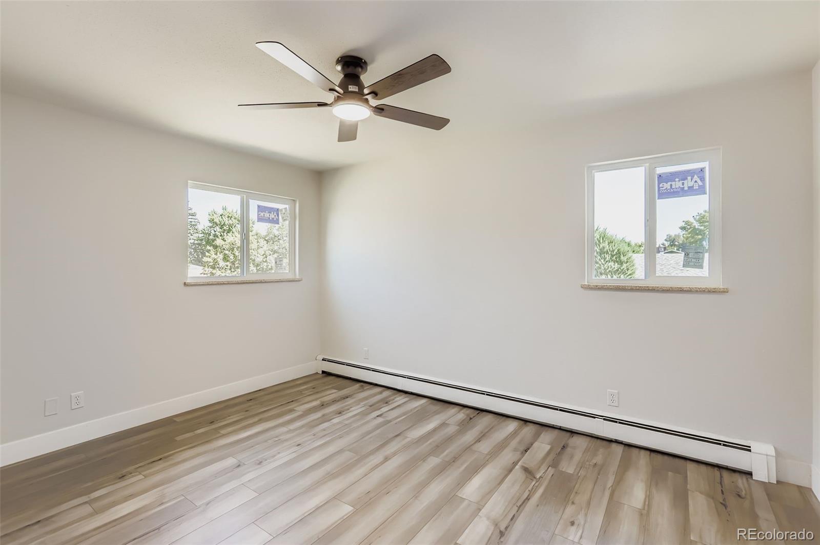 2412 West 20th Street Greeley, CO 80634 - Photo 14 of 23 a view of a big room with wooden floor closet and windows