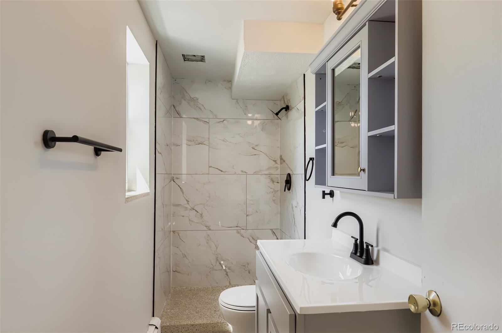 2412 West 20th Street Greeley, CO 80634 - Photo 17 of 23 a bathroom with a sink and mirror