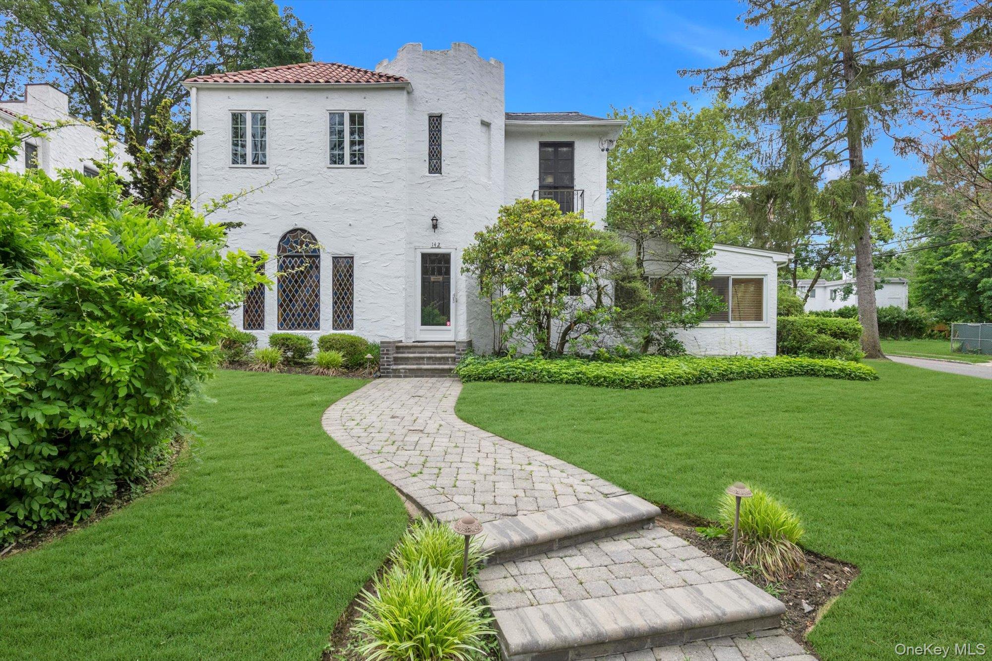 Mediterranean / spanish-style home featuring a front yard and stucco siding