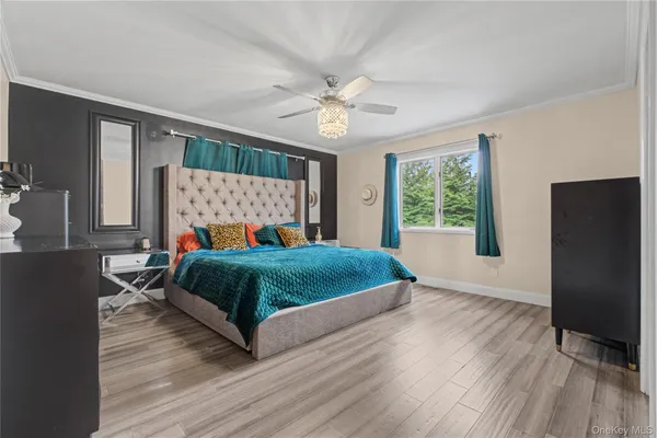 a bedroom with a bed window and a dresser