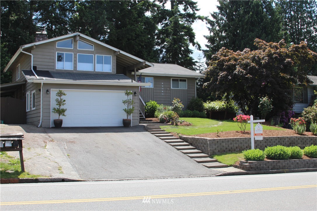 17515 Brook Boulevard Bothell, WA 98012 - Photo 2 of 36 a front view of a house with a yard garage and outdoor seating