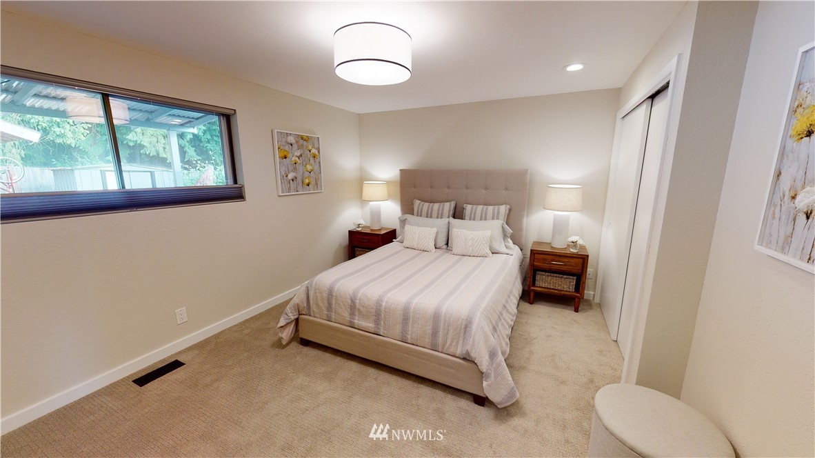 17515 Brook Boulevard Bothell, WA 98012 - Photo 12 of 36 a bedroom with a bed and a window