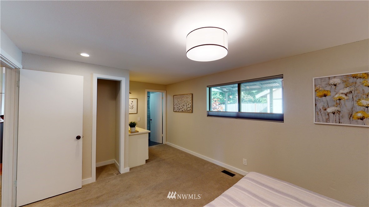 17515 Brook Boulevard Bothell, WA 98012 - Photo 13 of 36 a view of an empty room with window and wooden floor