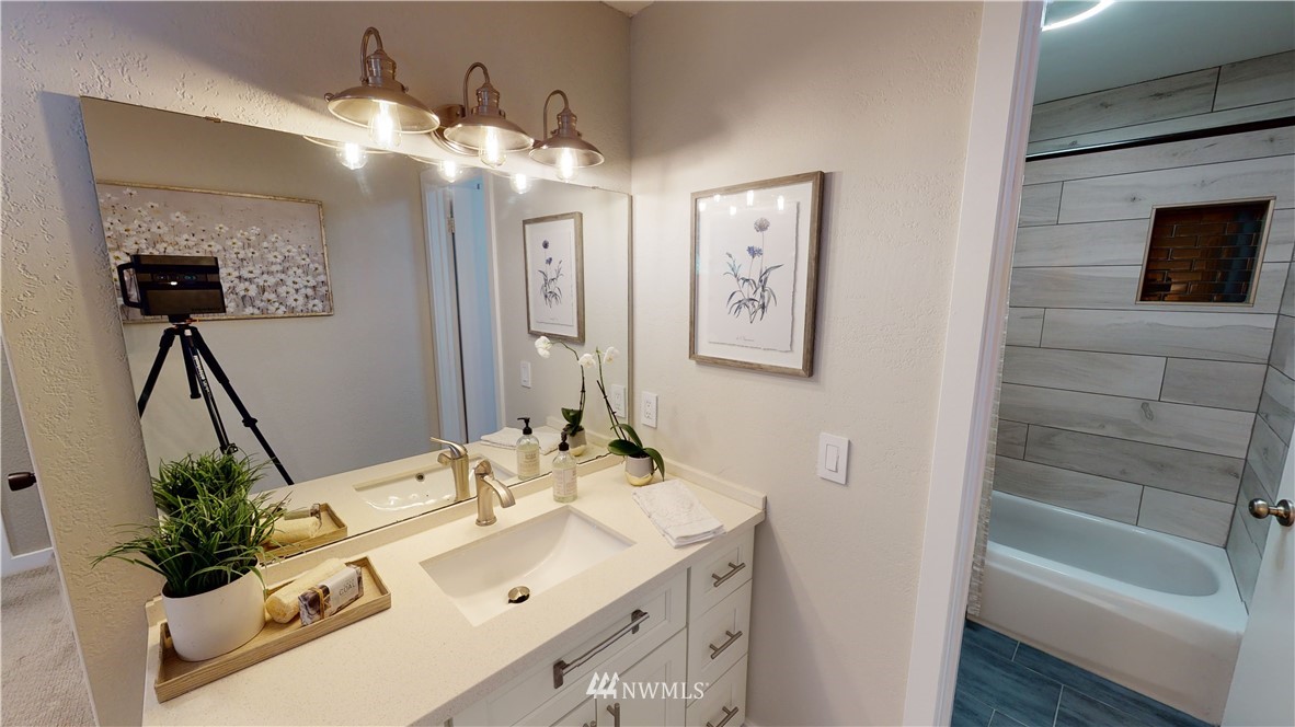 17515 Brook Boulevard Bothell, WA 98012 - Photo 14 of 36 a bathroom with a sink vanity tub and a mirror