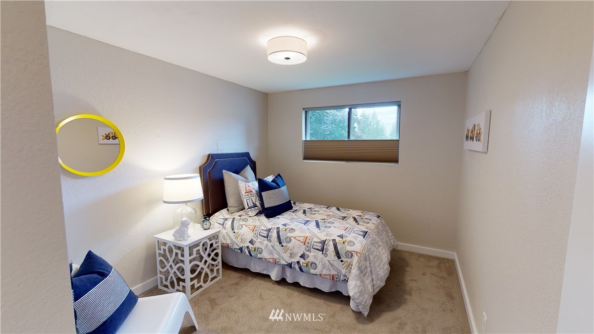 17515 Brook Boulevard Bothell, WA 98012 - Photo 16 of 36 a bedroom with a bed and a lamp next to a window