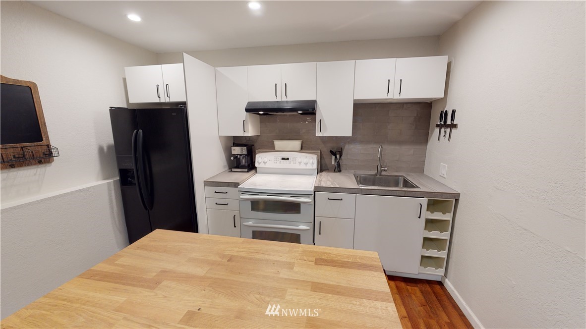 17515 Brook Boulevard Bothell, WA 98012 - Photo 20 of 36 a kitchen with a refrigerator stove and sink