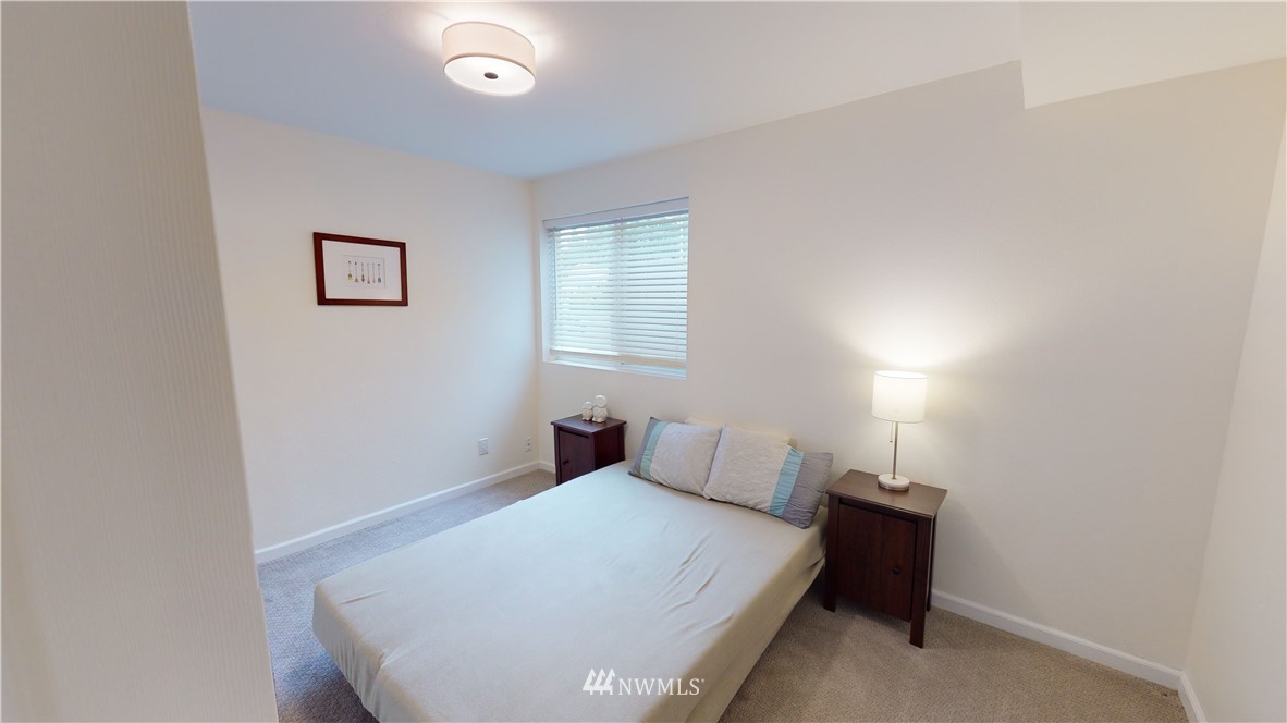 17515 Brook Boulevard Bothell, WA 98012 - Photo 23 of 36 a bedroom with a bed and a night stand