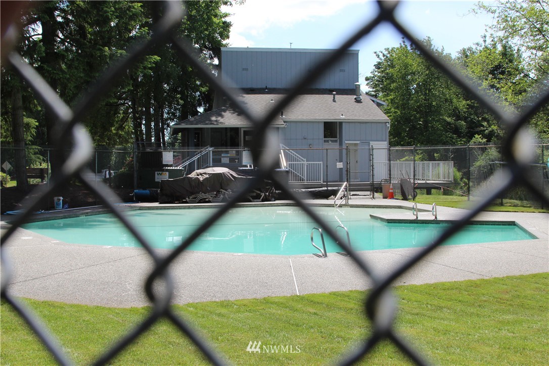 17515 Brook Boulevard Bothell, WA 98012 - Photo 32 of 36 a view of a swimming pool with a patio and a yard