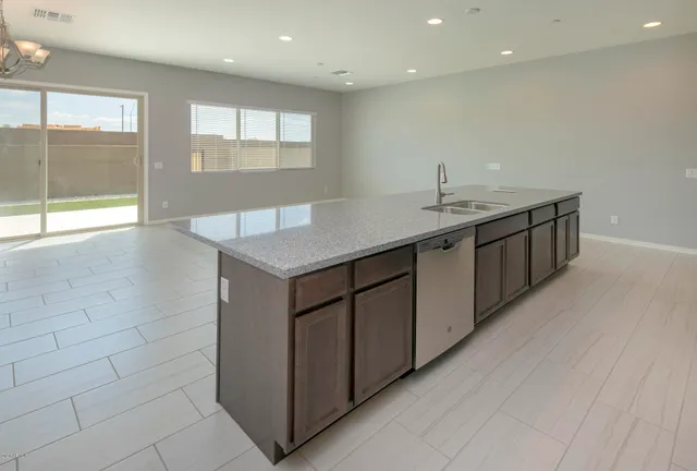 a kitchen with granite countertop wooden cabinets and stainless steel appliances