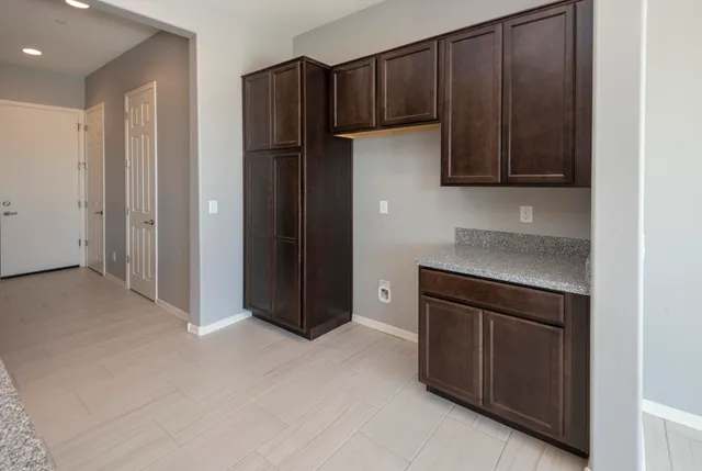 a kitchen with stainless steel appliances granite countertop a refrigerator and a sink