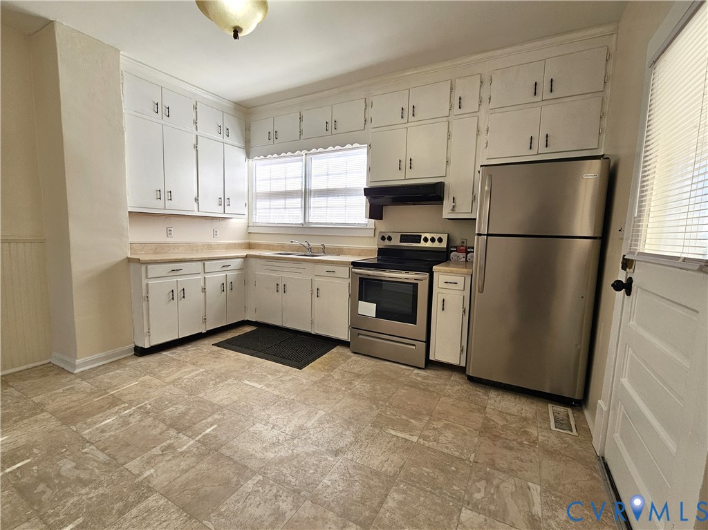 74 Conner Street Dillwyn, VA 23936 - Photo 12 of 46 a kitchen with white cabinets and white appliances