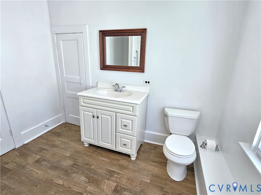 74 Conner Street Dillwyn, VA 23936 - Photo 23 of 46 a bathroom with a toilet a sink a vanity and mirror