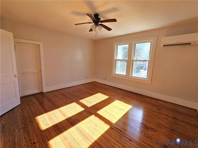 wooden floor in an empty room with a window