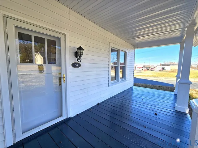 a view of an entryway and wooden floor