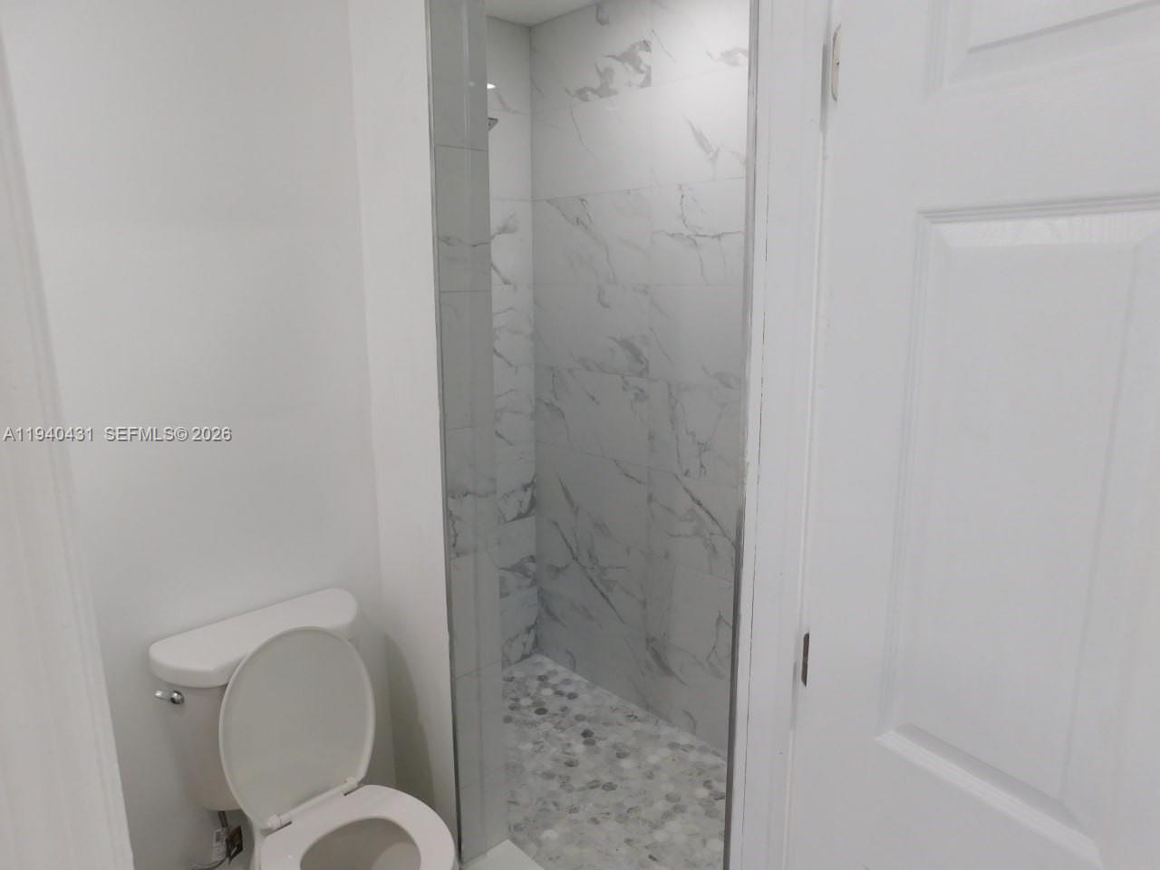 16240 Southwest 286th Street, Unit B Homestead, FL 33033 - Photo 5 of 7 a bathroom with a toilet and a shower