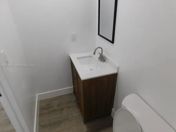 a bathroom with a sink toilet and mirror