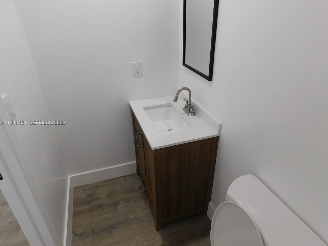 16240 Southwest 286th Street, Unit B Homestead, FL 33033 - Photo 6 of 7 a bathroom with a sink toilet and mirror