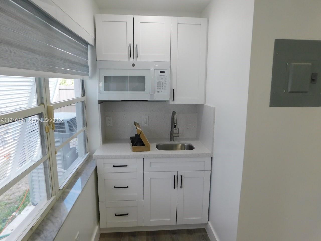 16240 Southwest 286th Street, Unit B Homestead, FL 33033 - Photo 7 of 7 a view of cabinets a sink and a stove in a kitchen