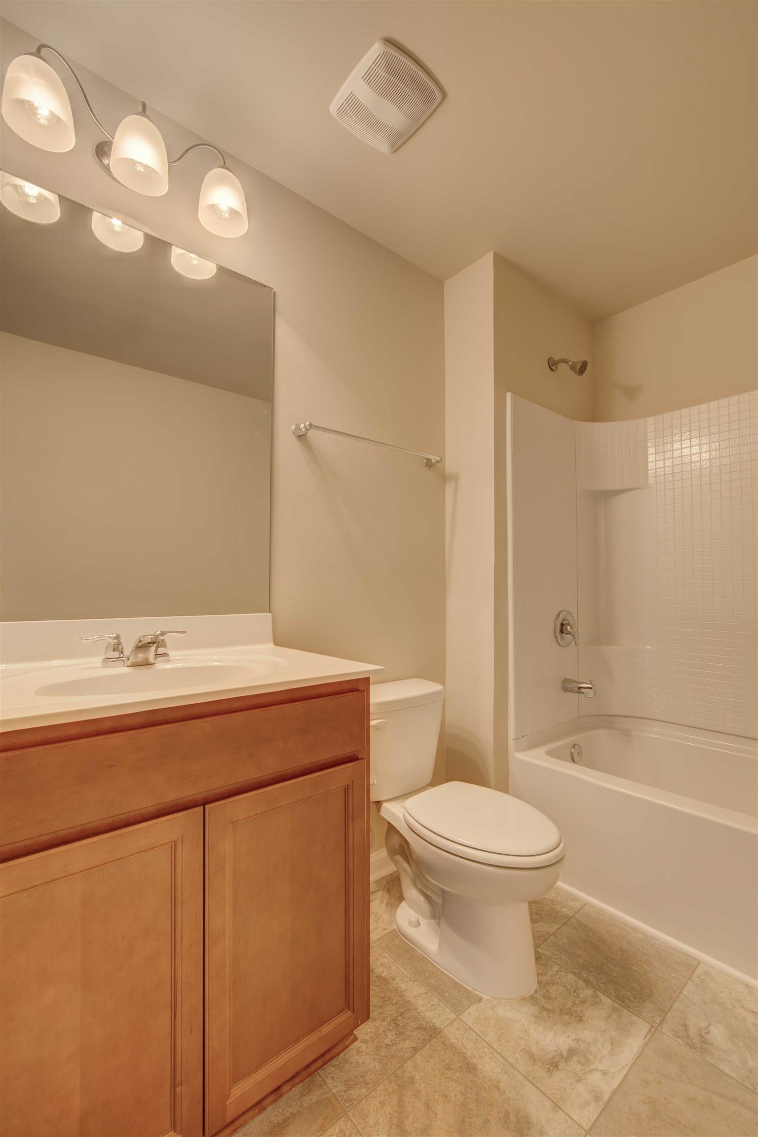 754 Prominence Road, Unit 71 Columbia, TN 38401 - Photo 21 of 28 a bathroom with a sink a toilet and shower