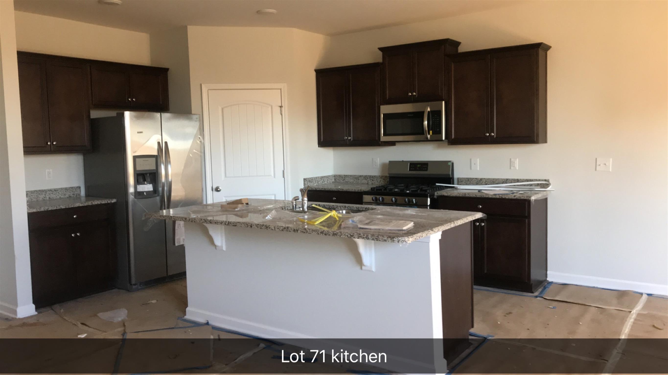 754 Prominence Road, Unit 71 Columbia, TN 38401 - Photo 4 of 28 a kitchen with stainless steel appliances granite countertop a stove a refrigerator and a microwave