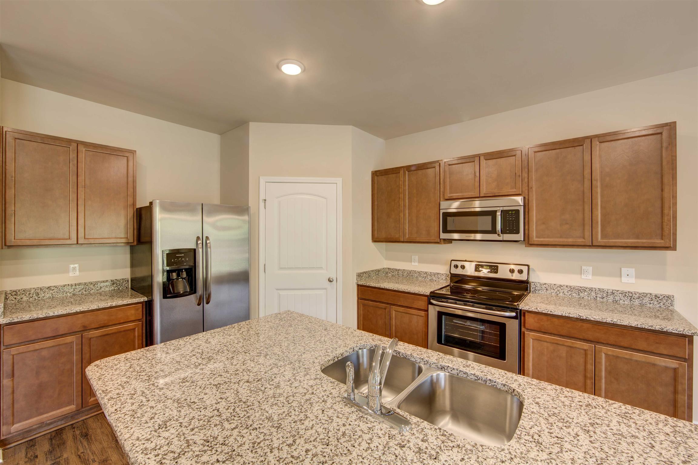 754 Prominence Road, Unit 71 Columbia, TN 38401 - Photo 9 of 28 a kitchen with stainless steel appliances granite countertop a sink stove microwave and refrigerator