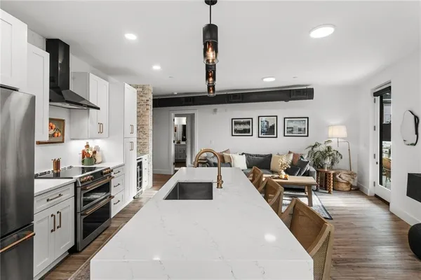 a kitchen with stainless steel appliances a refrigerator sink and cabinets