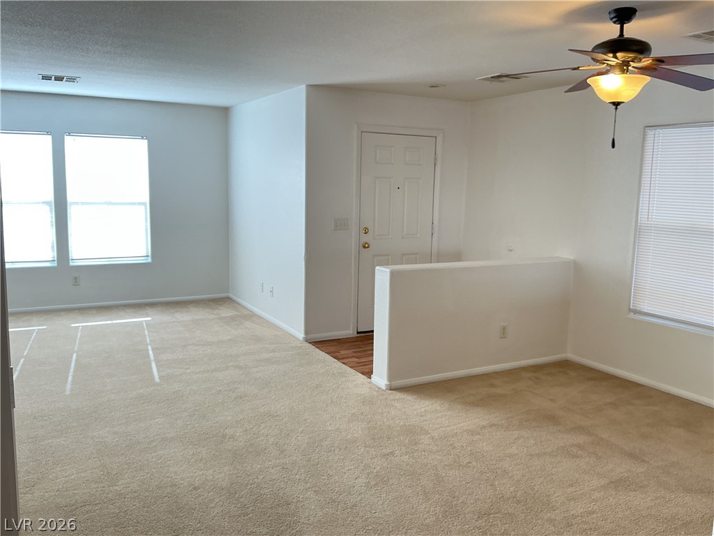 8108 Roundup Ridge Street Las Vegas, NV 89131 - Photo 10 of 21 A versatile living area with a fresh, neutral palette, perfect for personalized design.