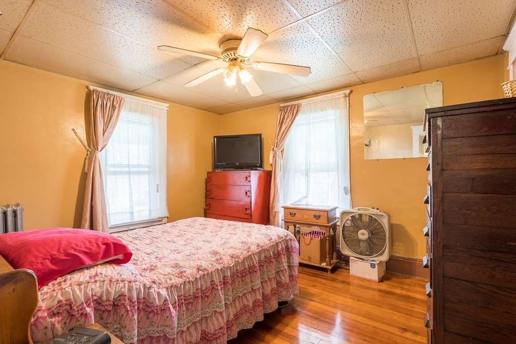 96-98 Johnson Street Springfield, MA 01108 - Photo 15 of 38 a bedroom with a bed and wooden floor