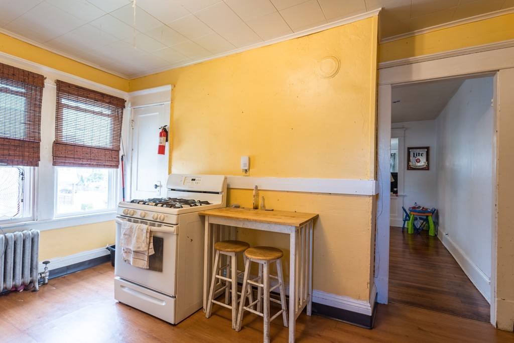 96-98 Johnson Street Springfield, MA 01108 - Photo 21 of 38 a view of washer and dryer with kitchen in the background