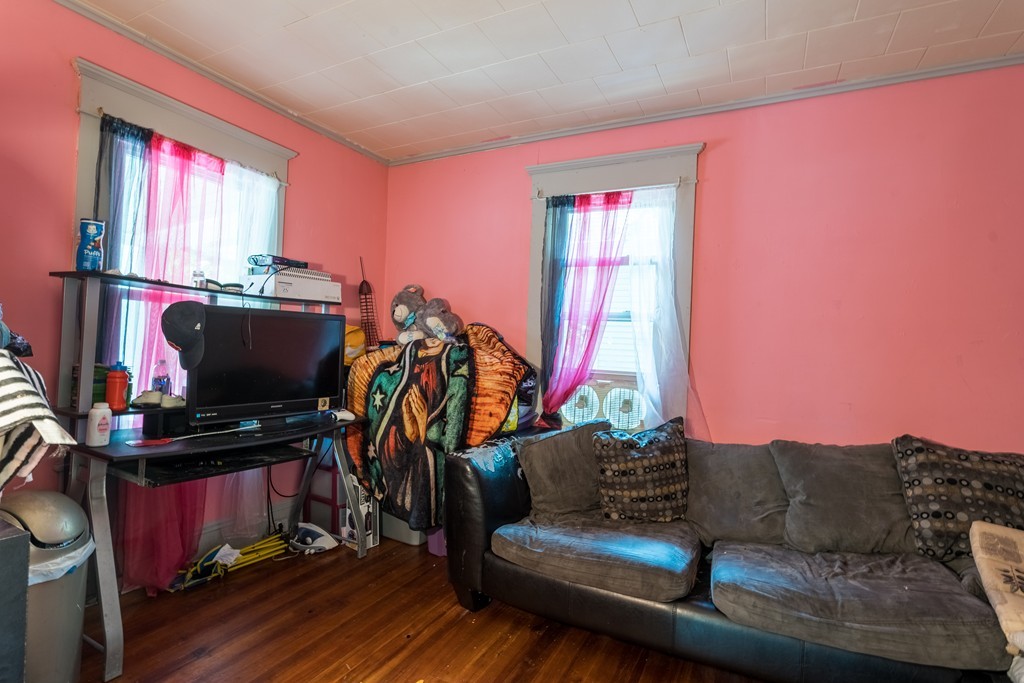 96-98 Johnson Street Springfield, MA 01108 - Photo 28 of 38 a living room with furniture a flat screen tv and a window