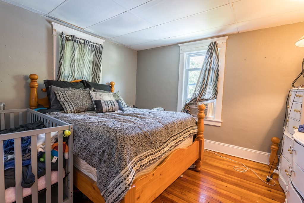 96-98 Johnson Street Springfield, MA 01108 - Photo 30 of 38 a bedroom with a bed and wooden floor