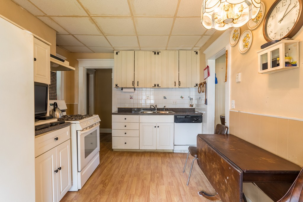 96-98 Johnson Street Springfield, MA 01108 - Photo 3 of 38 a kitchen with stainless steel appliances sink stove top oven and cabinets