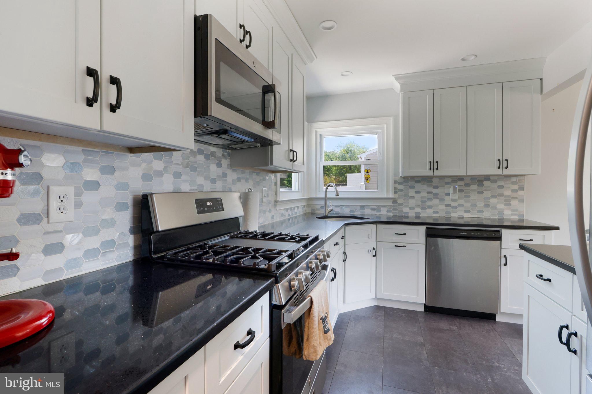 73 Burnt Tavern Road Brick, NJ 08724 - Photo 13 of 31 a kitchen with stainless steel appliances granite countertop a sink stove and cabinets