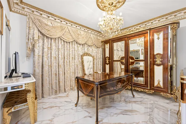 a view of a dining room with furniture a chandelier and wooden floor