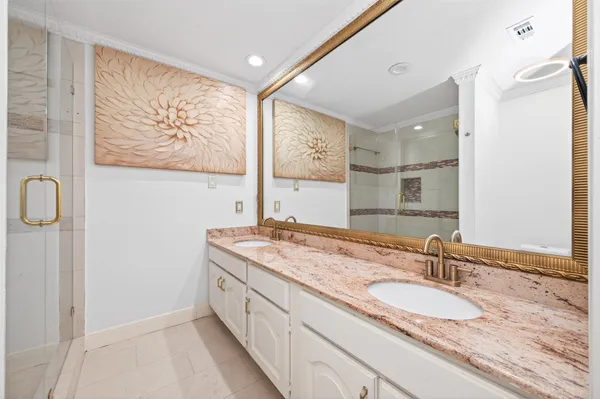a bathroom with a shower a mirror and a sink