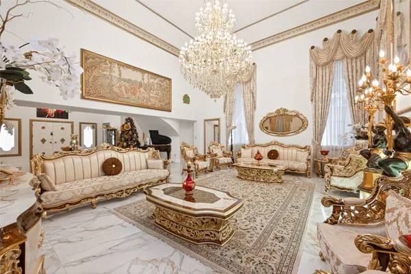 a living room with fireplace furniture and a chandelier