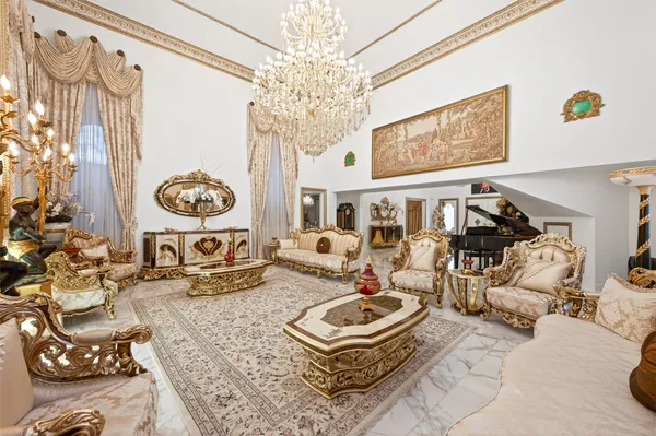a living room with furniture and a chandelier