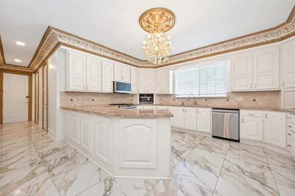 a kitchen with a refrigerator a sink and cabinets
