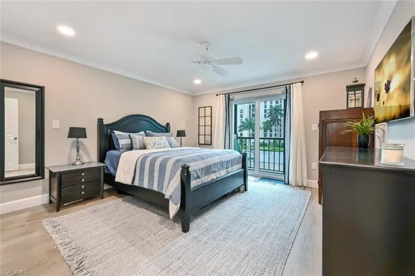 a bedroom with a large bed and a flat tv screen