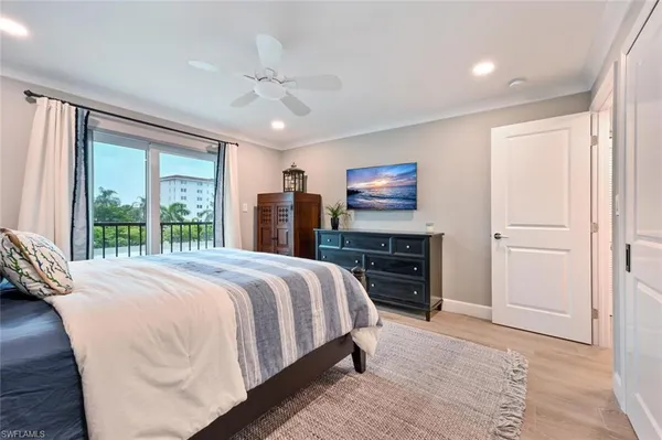 a bedroom with a large bed and a flat tv screen