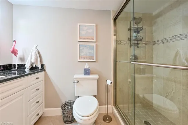a bathroom with a toilet a sink and shower